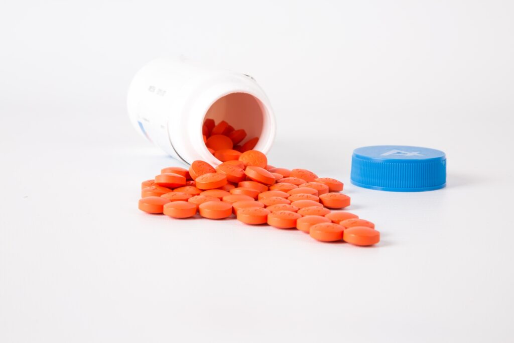 Image depicting pills spilling out of pill bottle